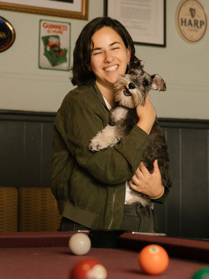 Erica Rose smiles and cuddles her dog, Patty, at Ginger’s Bar in Brooklyn.