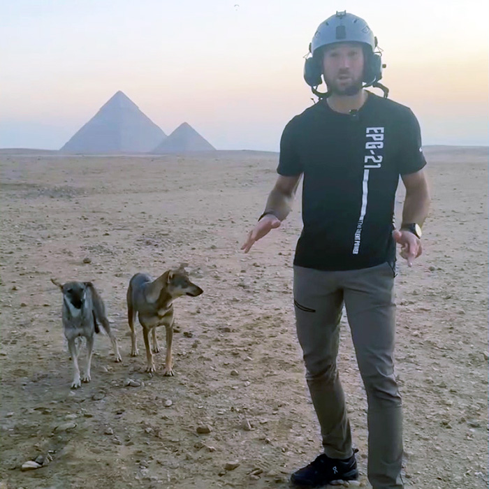 dog with another pup in front of pyramid