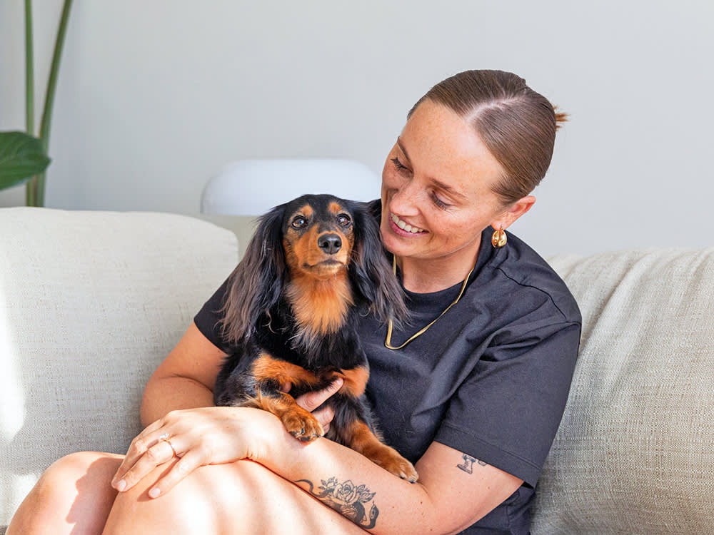 Woman with dog on the sofa