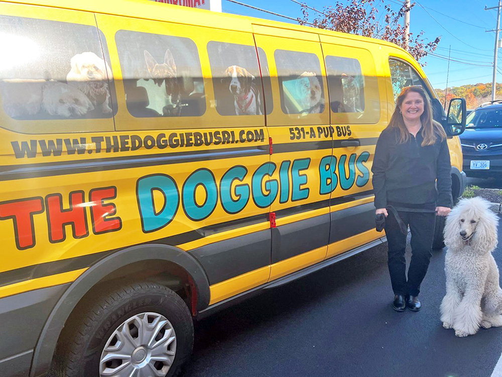 The Doggie Bus with a canine customer standing nearby