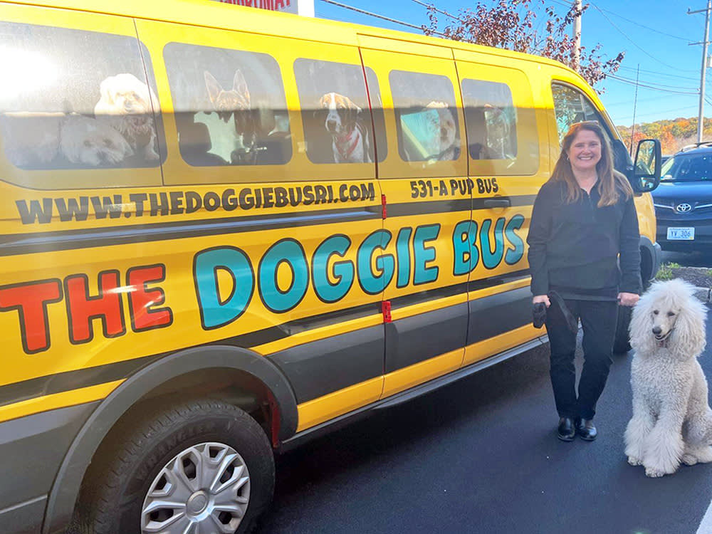 The Doggie Bus with a canine customer standing nearby