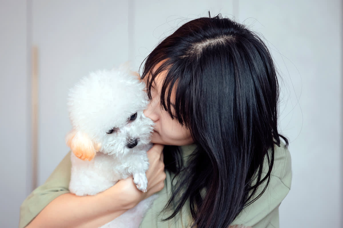 person kissing a dog