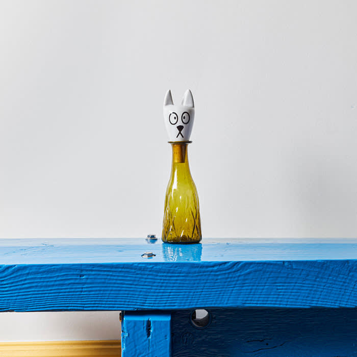 white cat bottle stopper in a vase