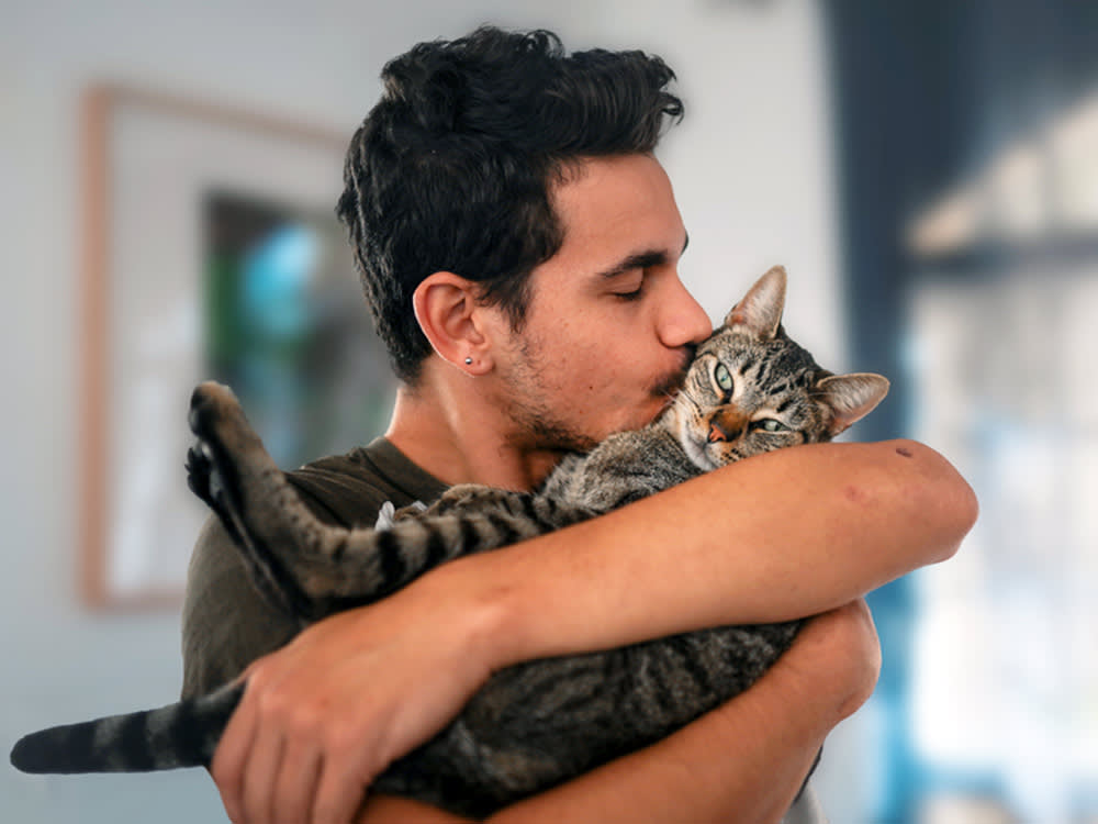 Man holding his cat.