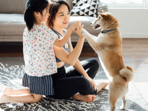 mom and daughter playing with puppy