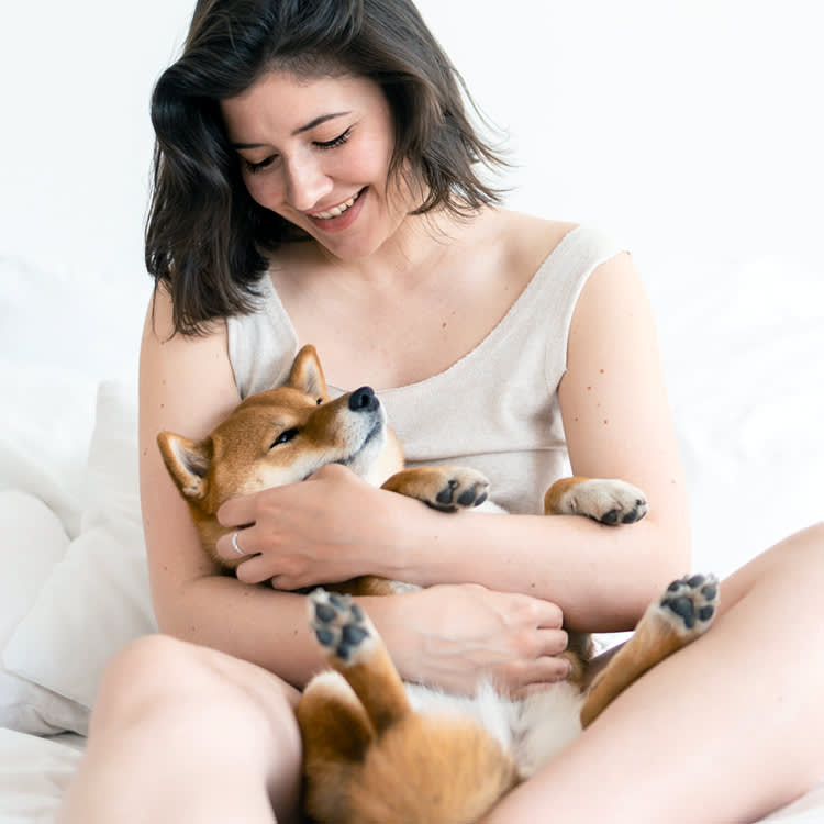 a woman cuddles her dog