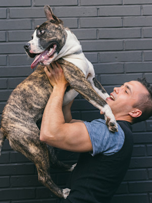 person holding up dog