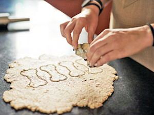 Woman baking dog treats at home.