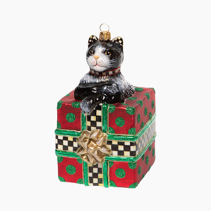 glass ornament of a cat popping out of a present with red and green packaging
