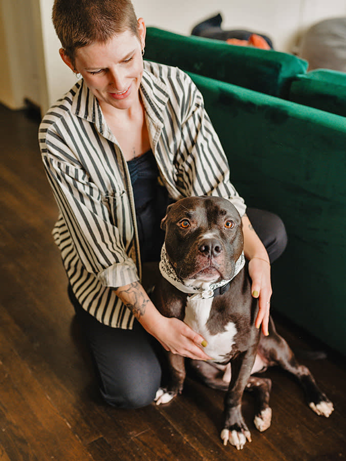 Woman and her pitbull dog inside.