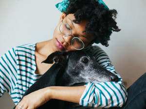 A woman hugging her dog. 