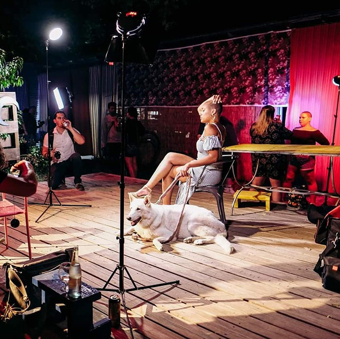 person sitting in chair with white dog