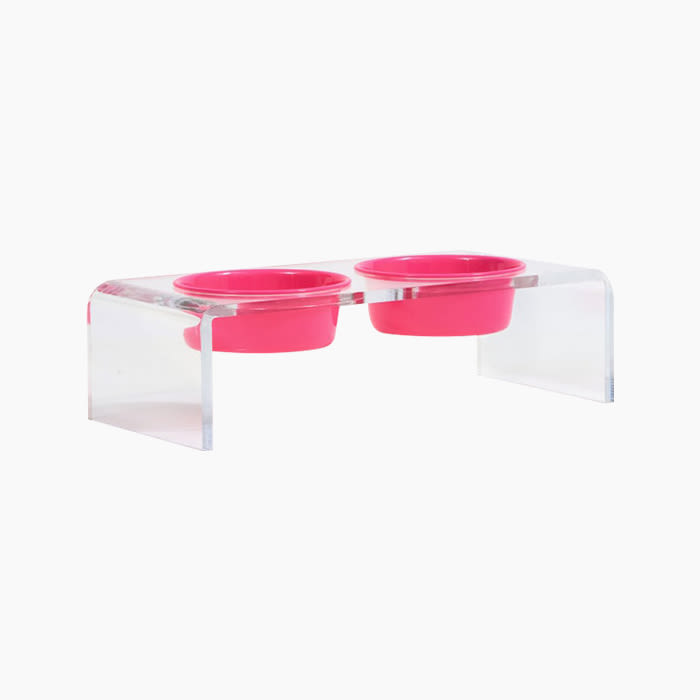 the lucite food and water bowl holder with hot pink bowls