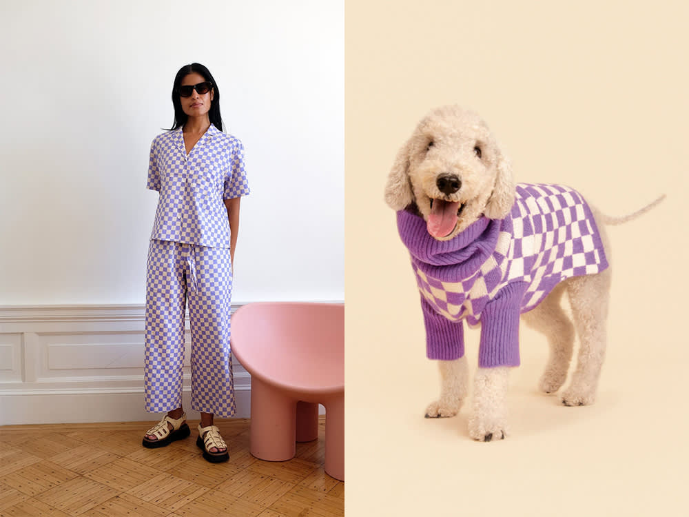 matching outfits: a woman in a purple and white checkered outfit, a small white dog in a purple and white checkered sweater