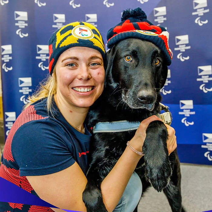 Carina Edlinger hugs her service dog, Riley