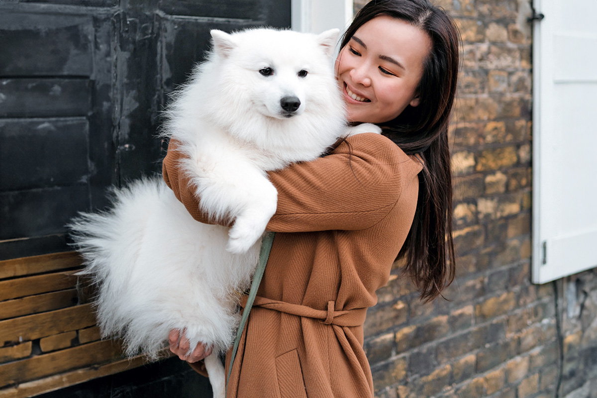 a person holding a large white dog