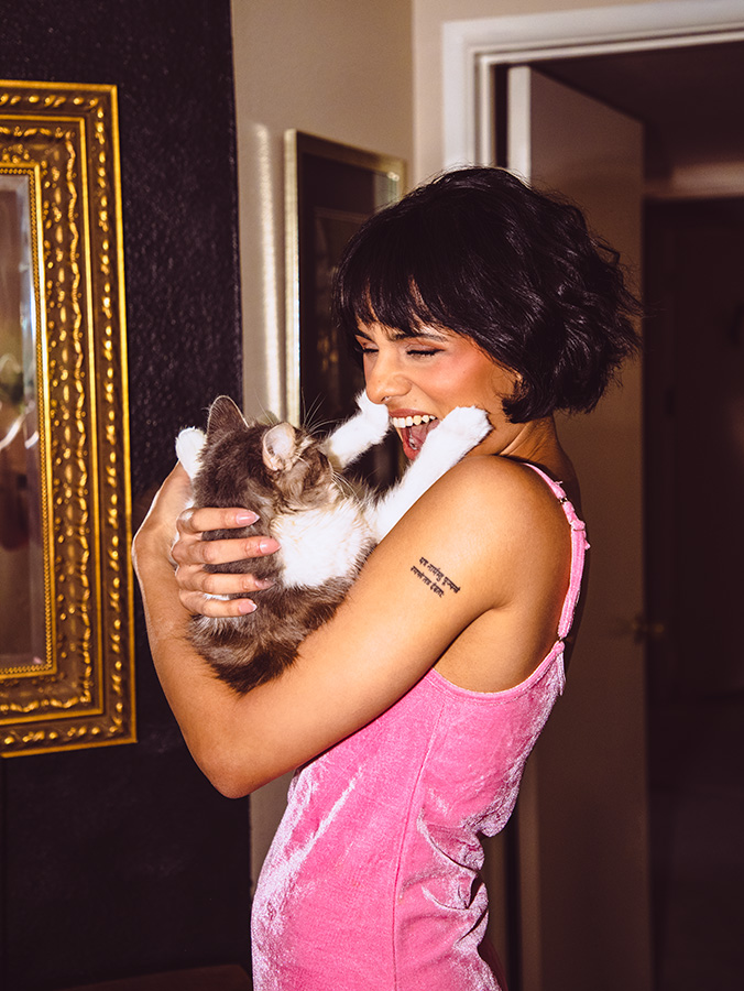 Oscar Wilde plays with Aparna Brielle, who giggles as her bats at her face.
