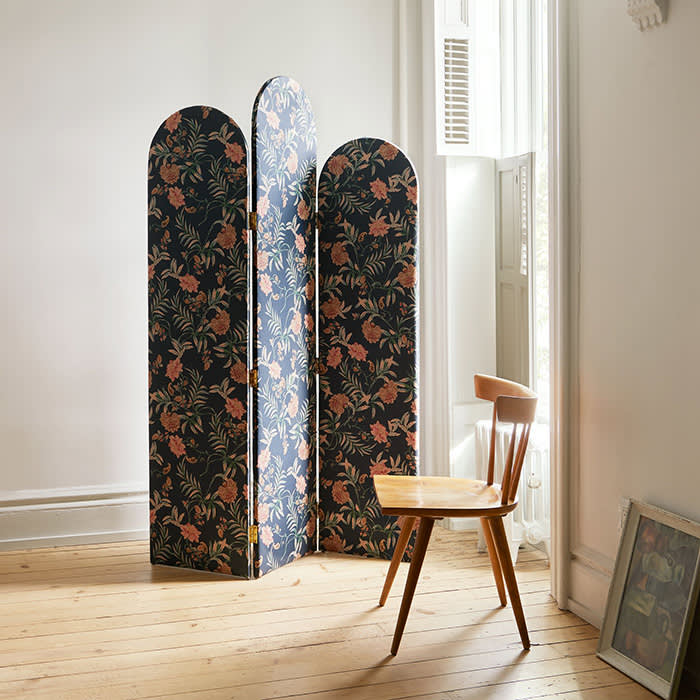 floral screen next to wooden chair