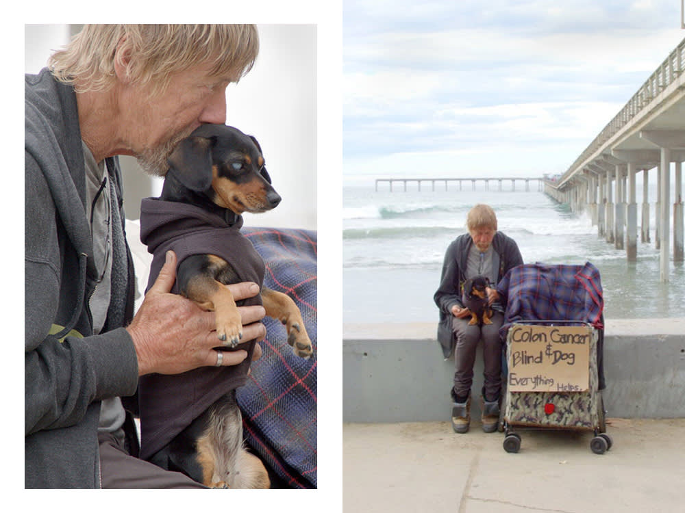 a man with a small blind Dachshund 