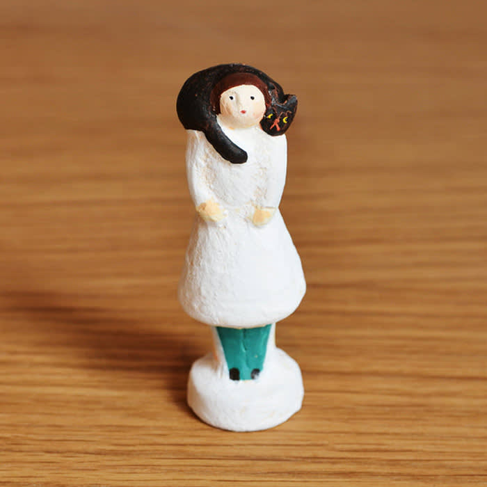 woman figurine with cat on her shoulders