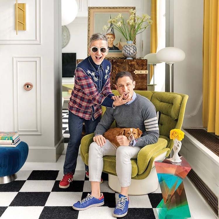 Instagram post of Johnathan and Simon with their dog Foxy in their modernly decorated living room with the caption, "Happy #Thanksgiving to you and yours from JA and his."