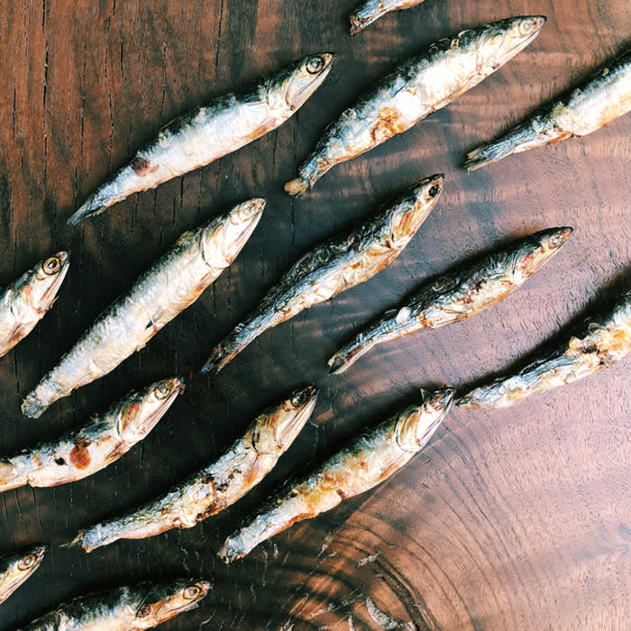 anchovies on wood cutting board