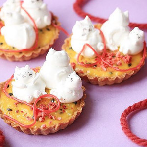small tart cakes topped with white cats