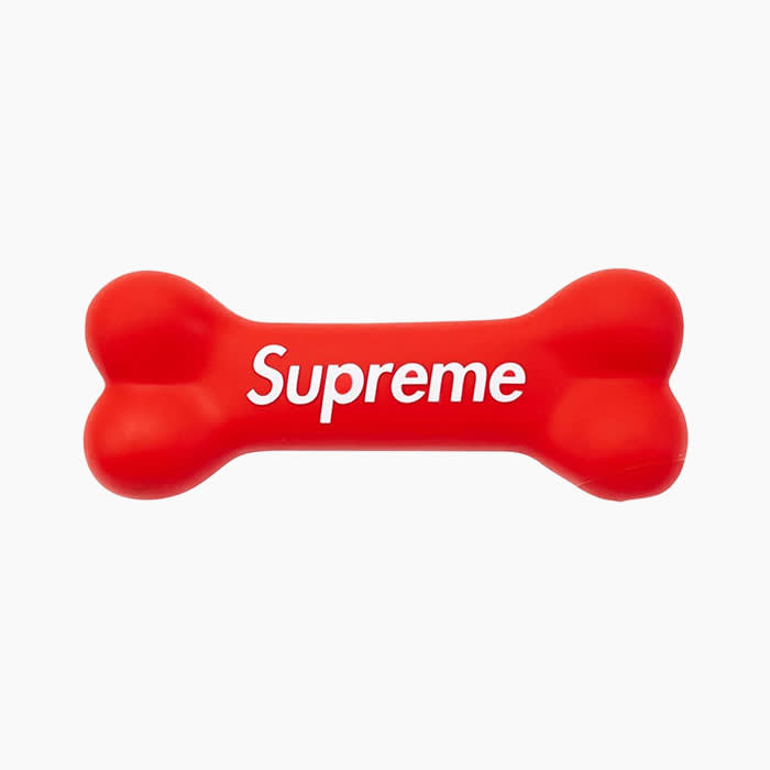 red dog bone toy with white lettering saying "supreme"