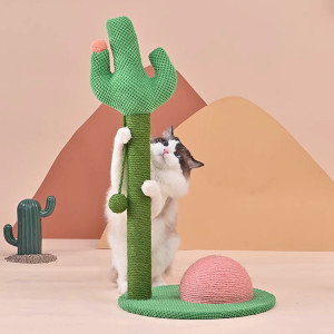 A black and white cat climbing a cactus shaped cat scratching post in front of a warm toned paper background of desert mountains