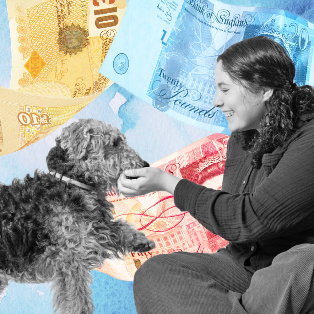 woman plays with a dog with pound notes in the background