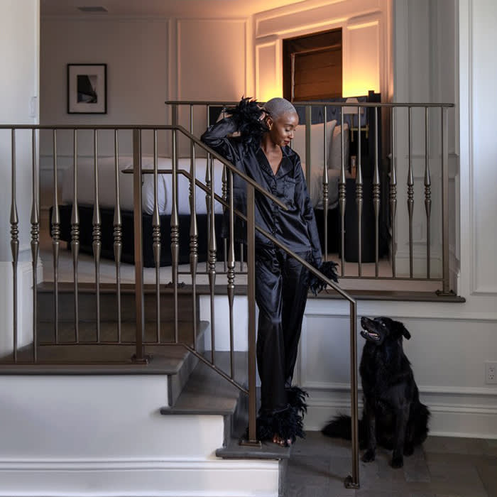 a guest and a black dog on a staircase at the Pendry Hotel
