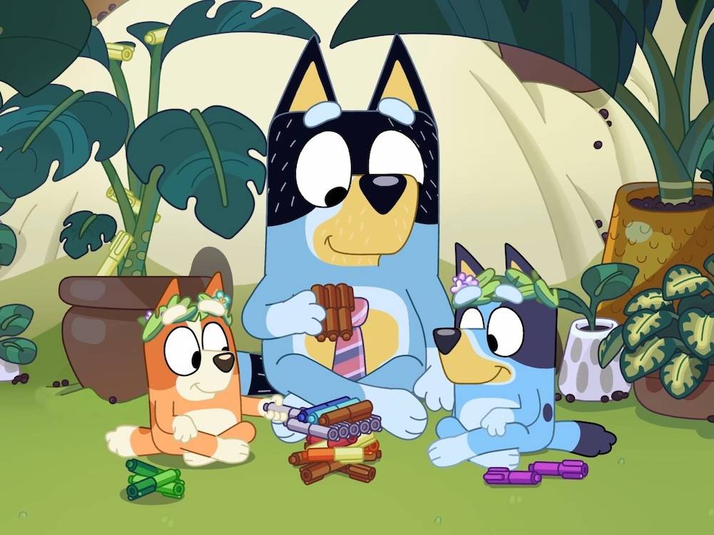 a picture of three cartoon dogs bluey, bingo and bandit sit cross legged in a circle
