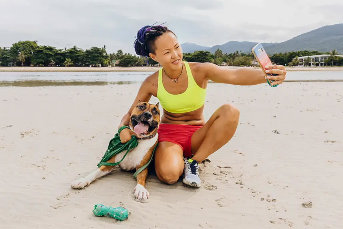 Person taking a photo with a dog