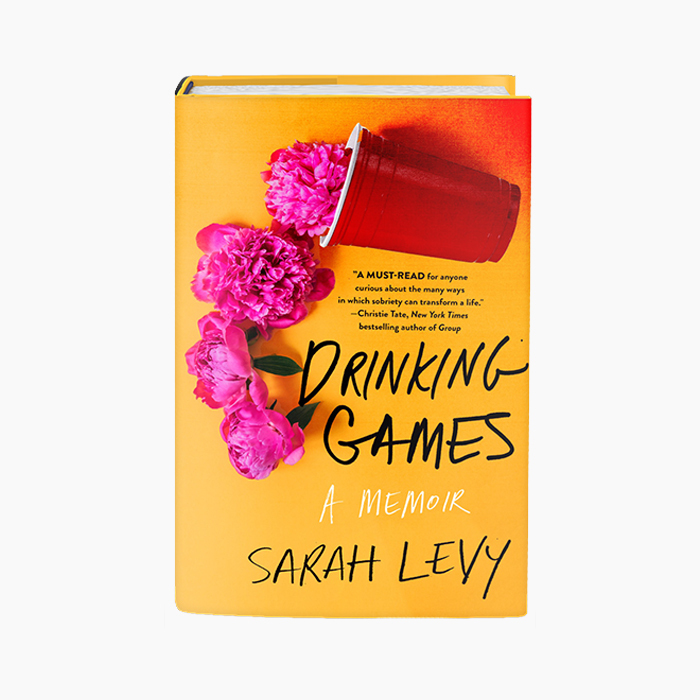 hardcover book with orange background and red plastic cup