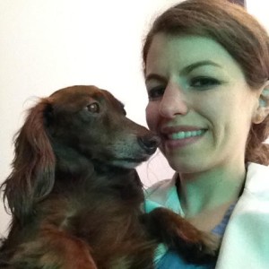 Dr. Amy Fox cuddling a dog
