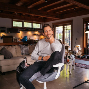 Andrew Knapp sitting with his two dogs. 