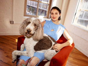 Gracie McGraw on a red chair with her dog