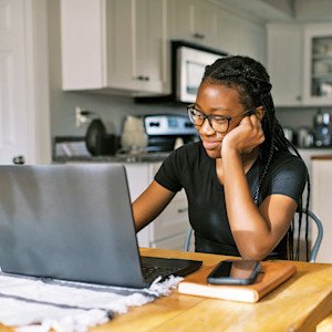 Woman watching a video on her laptop at home.
