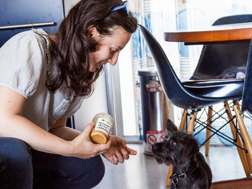 Jessica Koslow and her small black dog, Munk