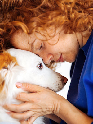 woman head to head with dog