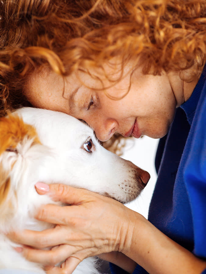 woman head to head with dog