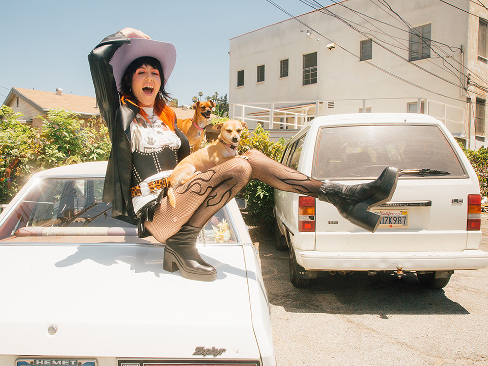 Dani Miller's with her two dogs on a car