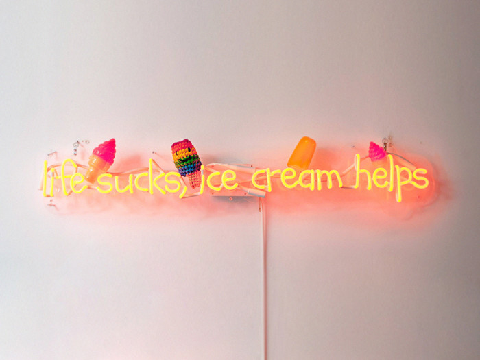 neon sign that says "life sucks, ice cream helps"