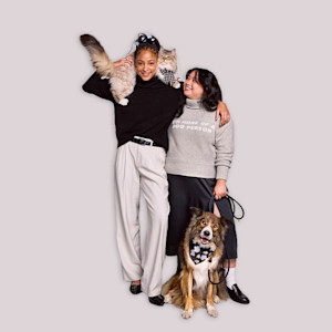 Two women, a dog, and a cat pose in Target Cuddle Collab merchandise