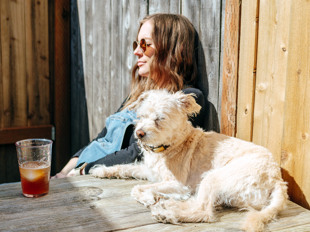 Dog and woman soaking up the spring sun.
