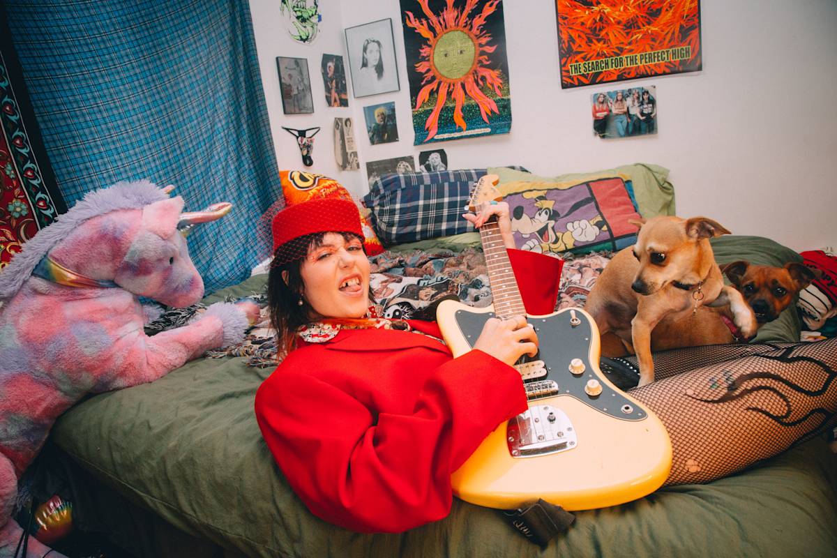 Dani Miller playing guitar with her dog
