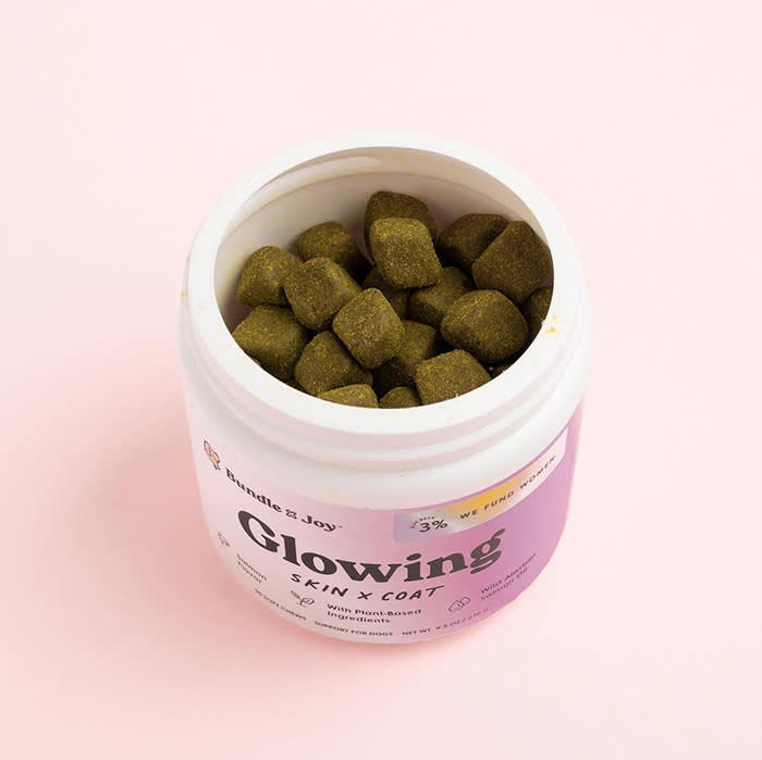 dog treats in round container with pink label