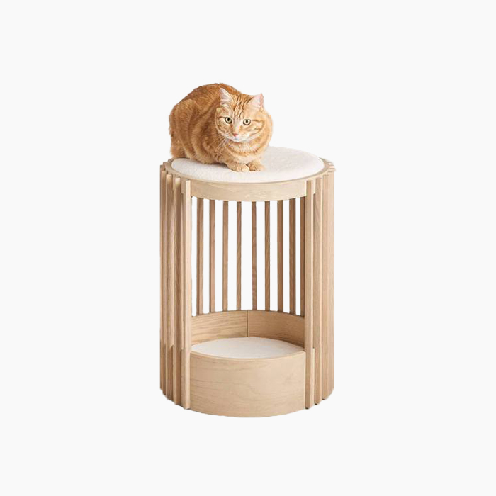 the cat bed in wood with an orange cat on top