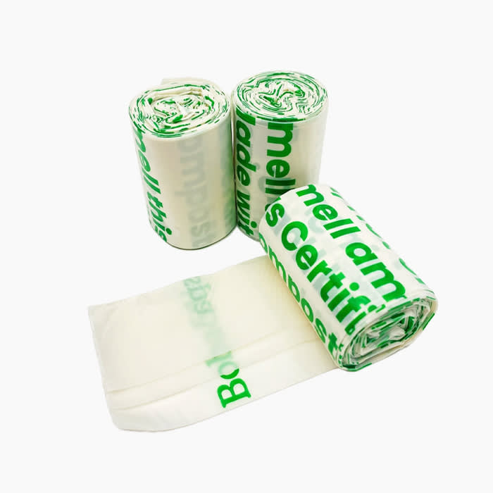 clear poop bags with green lettering