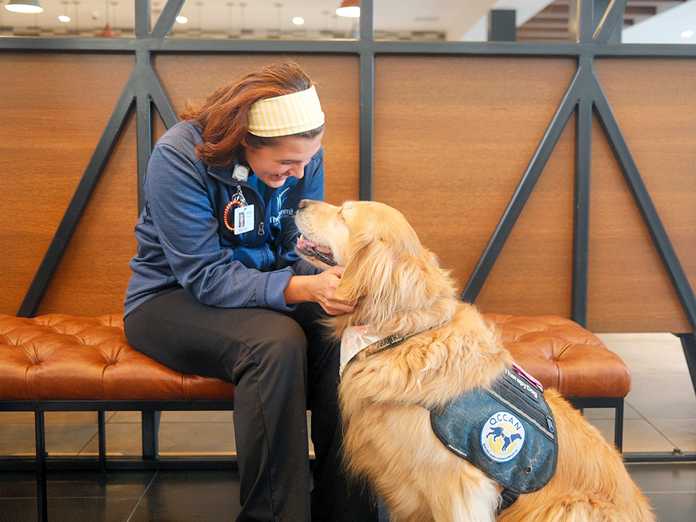 woman pets lucy the service dog 